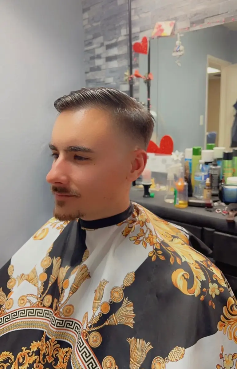 Classic side part with a smooth fade completed by Freda