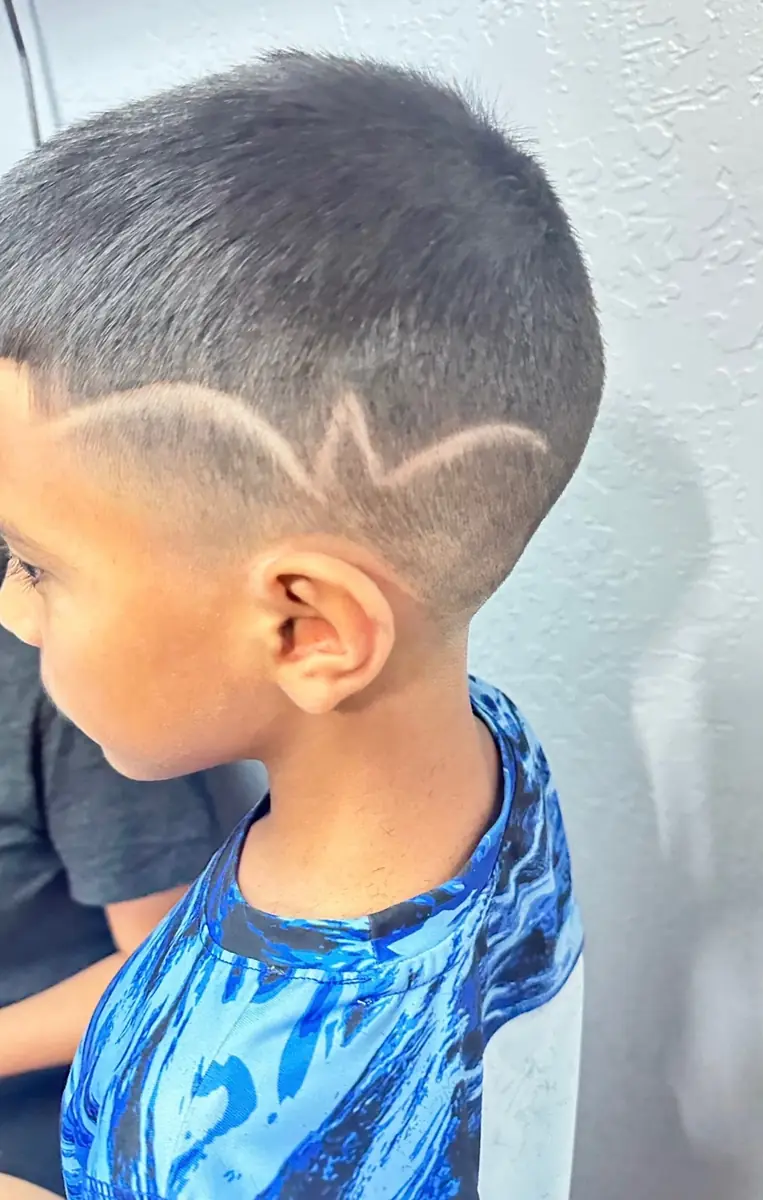 Kids fade with a custom shaved design above the ear